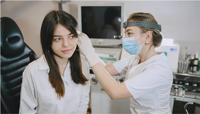 Doctor examining a traveler’s ear
